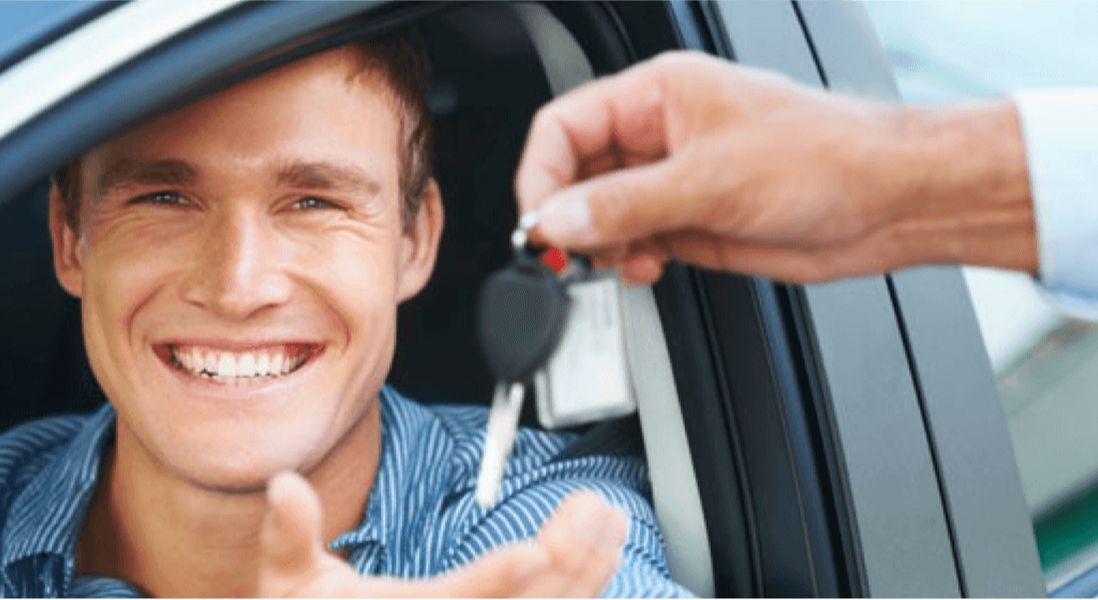 Smiling man with car keys